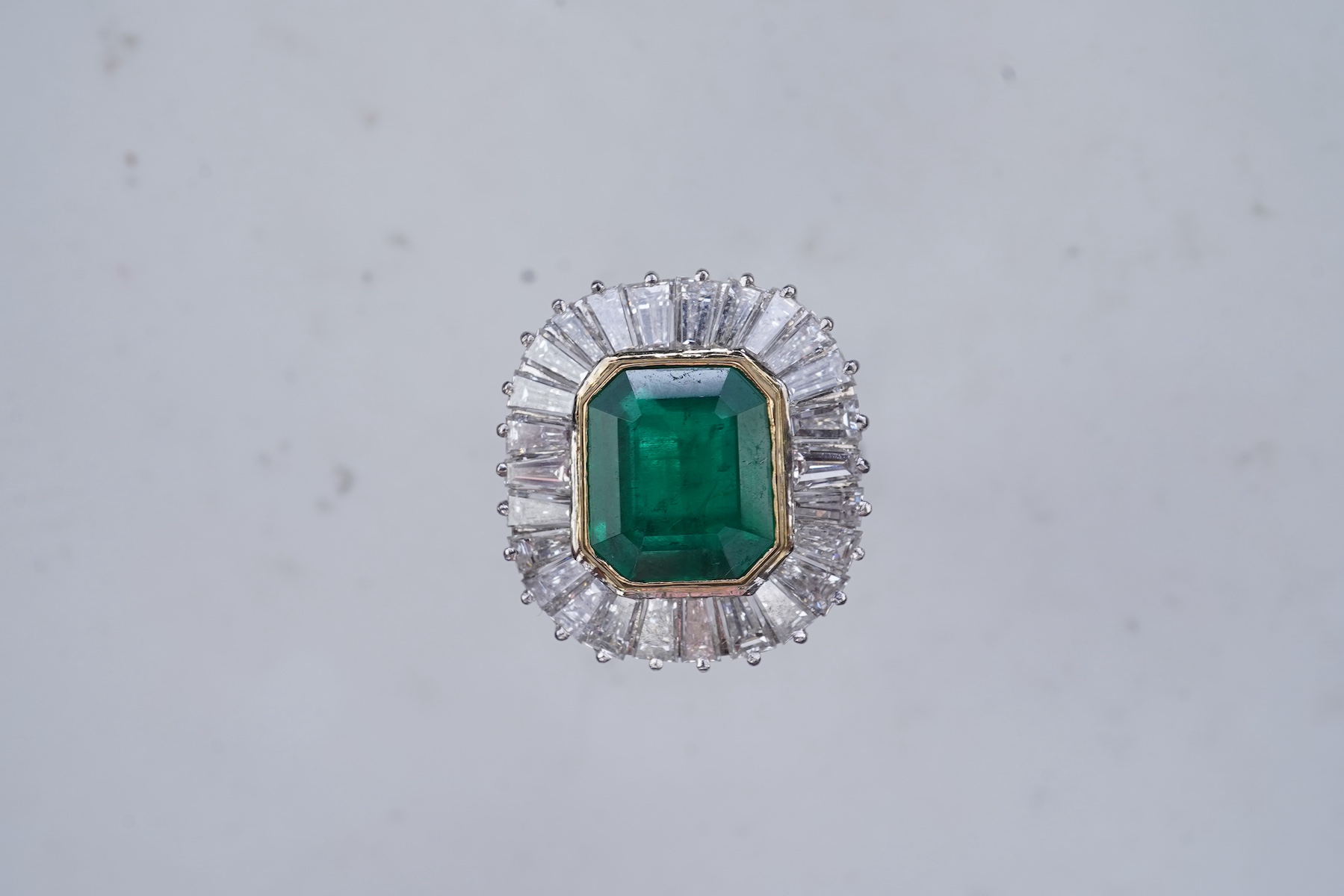 An emerald and diamond ring